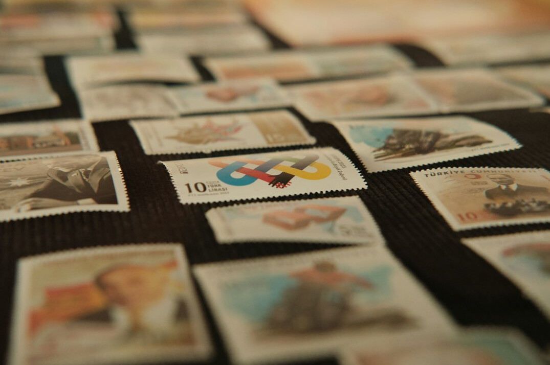 person sorting stamps