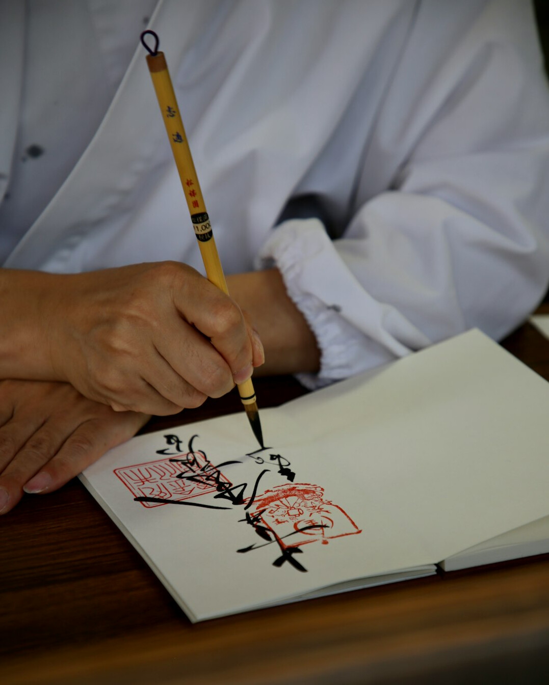 person practicing calligraphy