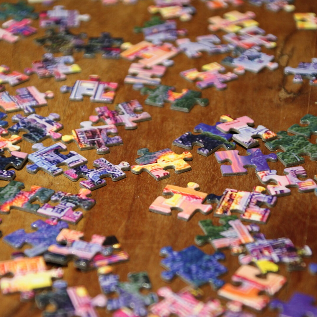 person doing puzzle on table