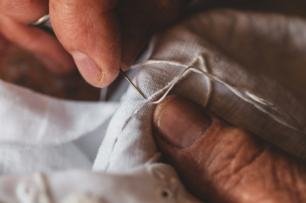 person embroidering by hand